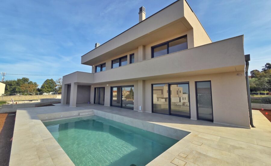 Luxury modern villa with swimming pool and large glass sliding doors, ideal for coastal living.