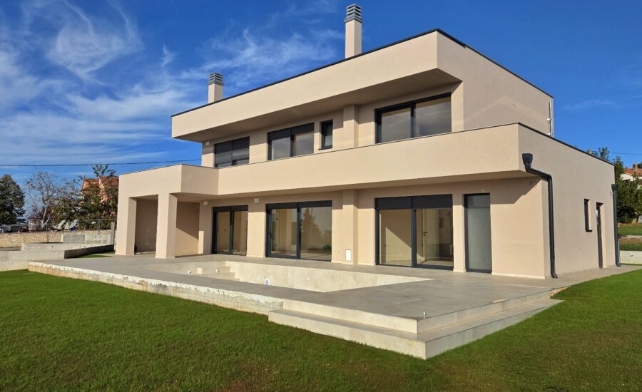 Luxury modern villa with swimming pool and large glass sliding doors, ideal for coastal living.