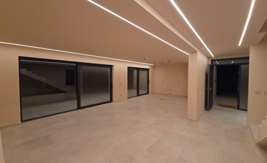 Modern villa interior room with minimalist design, LED ceiling lighting, and neutral tones in Baderna near Poreč
