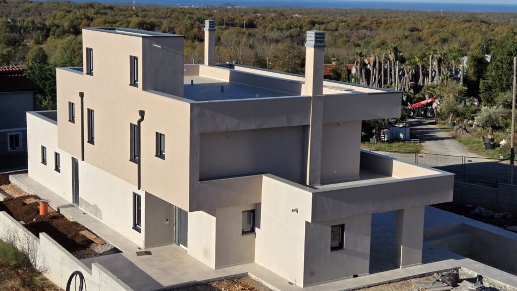 Rear view of modern multi-level house with minimalist design.