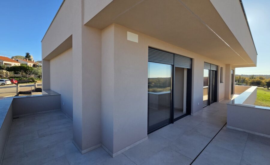 Newly built modern two-story home featuring a spacious terrace, floor-to-ceiling windows, and a tiled pool in the foreground