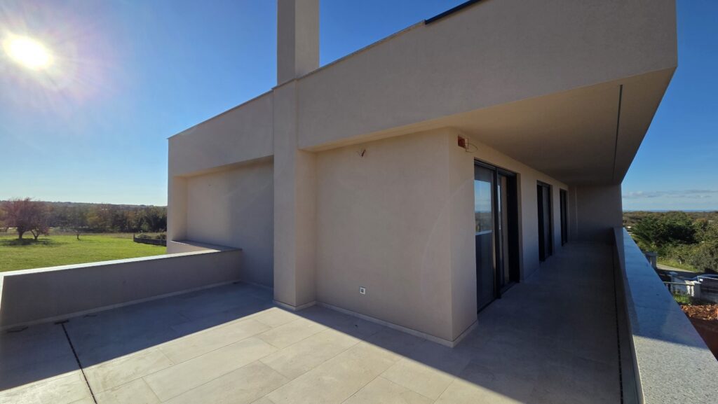 Modern house side entrance with clean lines and lawn.